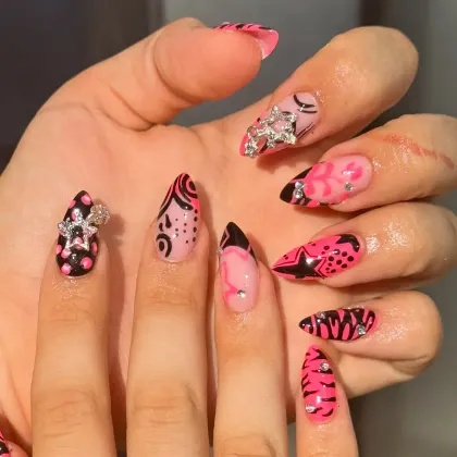 Almond nails in hot pink and black with animal print, swirls and silver charms